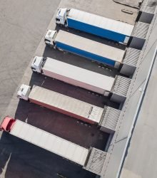 Aerial view of trucks unloading in logostics center